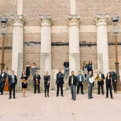 Musicians posed in front of roman columns
